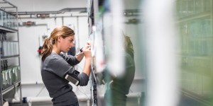 A woman is writing her note on the container 
