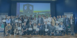 A diverse group of people is gathered together, smiling and proudly holding their certificates, celebrating their achievement of completing the Venture Founder program.