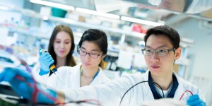 A man and two women are in a lab. 